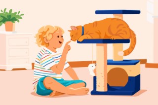 A boy kneeling on a rug and playing with a cat on a scratching post.