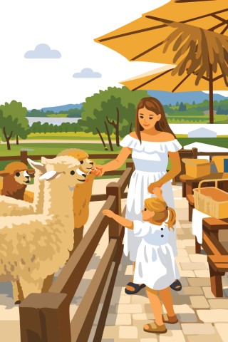Young mother and daughter visiting a rural farm to feed domestic llamas.