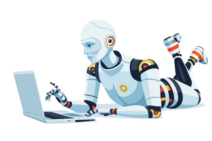 Humanoid robot lies on the floor while focused on a laptop screen in a bright room.