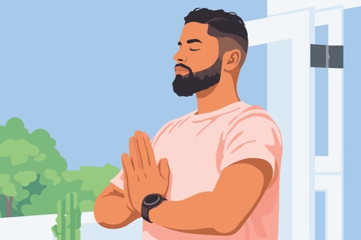 Man practicing yoga and meditation in a bright room.