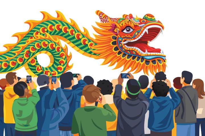 Large crowd of people celebrating a festival with a traditional giant dragon dance.