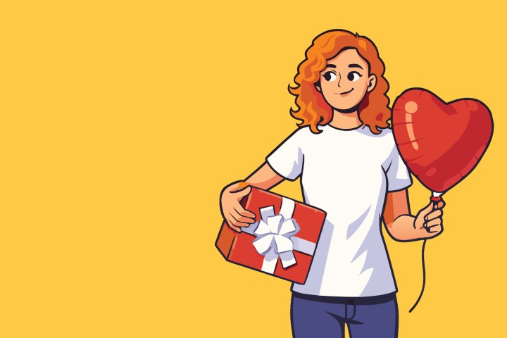 Happy young woman holding a vibrant red heart balloon while celebrating love.