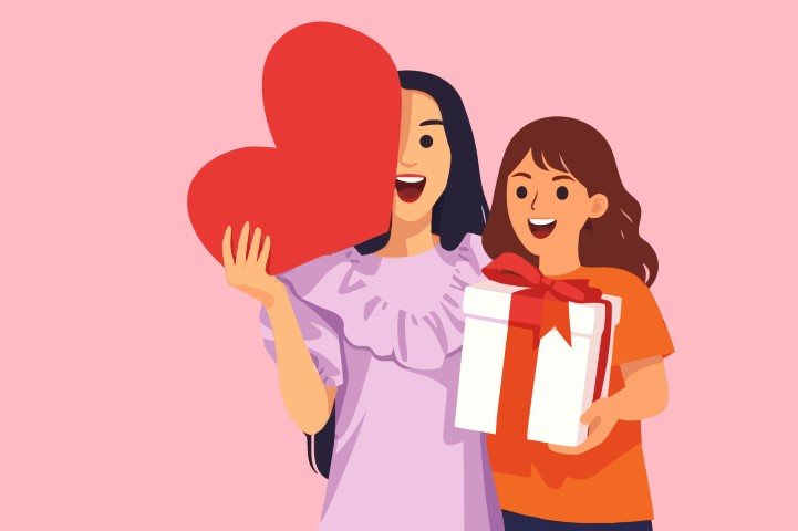 Two sisters or friends playing and laughing with a large red heart.