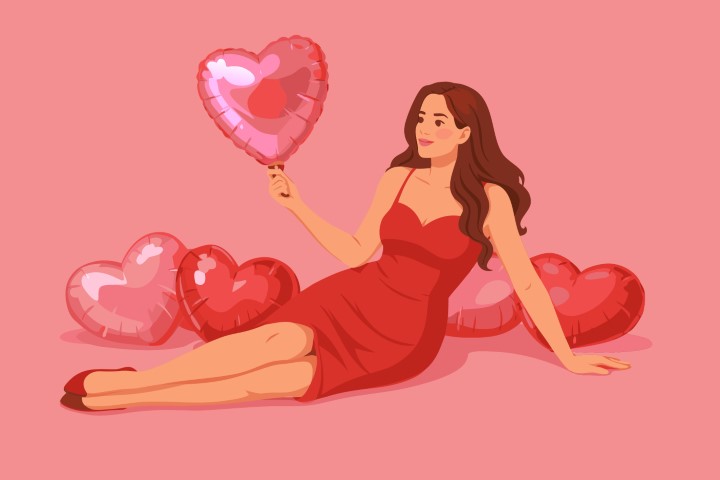 Elegant woman in a red dress lying down surrounded by heart balloons.