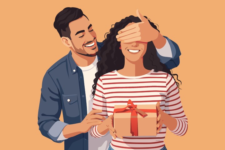 Man surprising a woman by covering her eyes while holding a gift box.