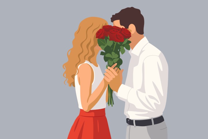 A man surprises his partner with red roses in a minimalist modern setting.