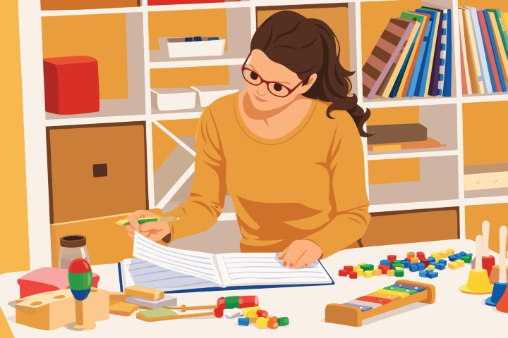 Teacher organizing educational materials and documents at a desk.