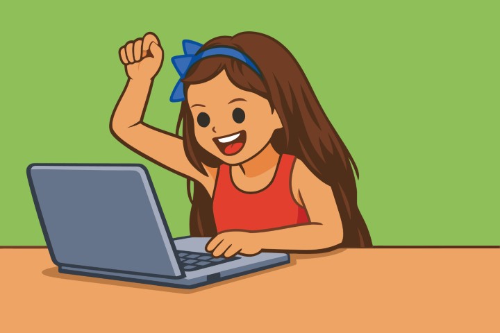 Happy young girl cheering while looking at a laptop computer.