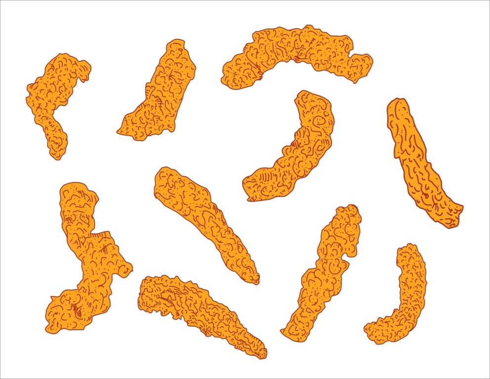 Scattered crispy fried chicken tender strips isolated on a white background.