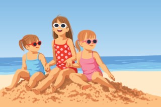 Three happy young girls sitting together on a sandy beach during summer vacation.
