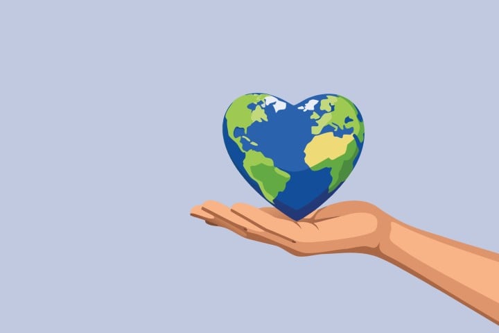 Human hand holding a floating earth globe with a green heart shape.