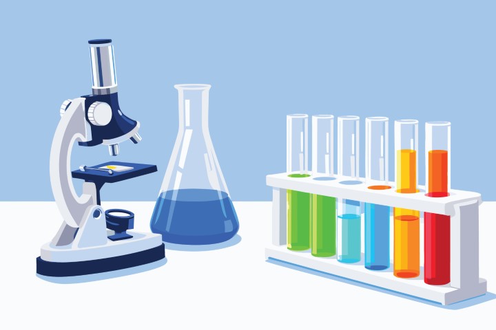 Professional laboratory workspace with microscope and glass chemical equipment.