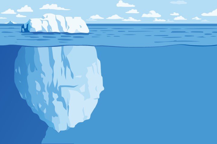 Large iceberg floating in deep blue ocean water with underwater view.