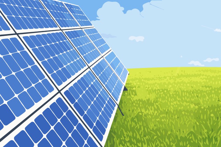 Large solar panel array positioned in a green field under a clear blue sky for clean energy.
