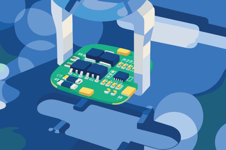 Industrial robotic hand holding a green microchip over a blue circuit board.