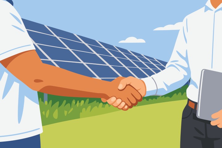Professional handshake between two business partners in front of a solar farm.